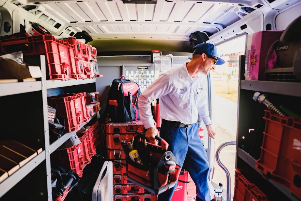technician-on-truck | Patrick Riley Services technician with a toolbox on a Patrick Riley truck